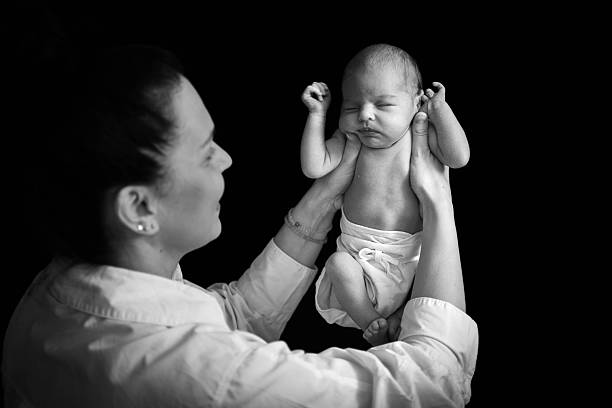 Just born baby in the arms of her  mother
