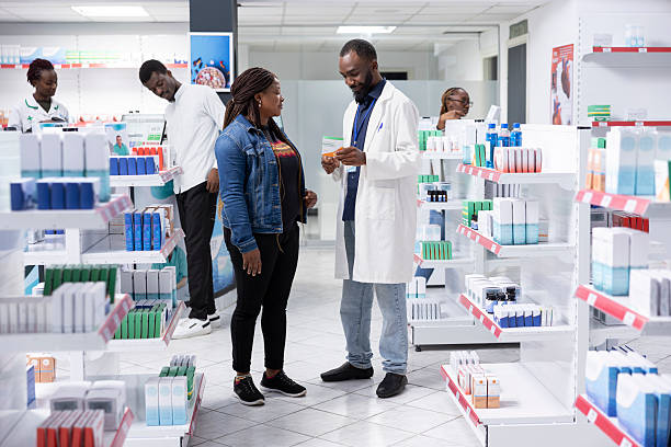 istock Male pharmacist providing detailed medication advice to a client 2233596565