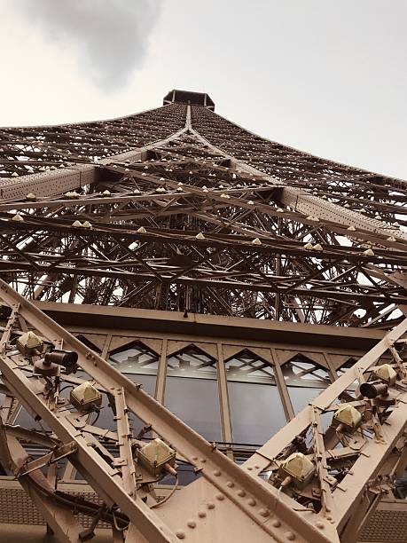 Experience the Eiffel Tower from an extraordinary angle with this striking upward shot. The intricate latticework and monumental scale are highlighted, offering a new vision of the iconic Parisian landmark. This compelling photograph captures both strength and artistry, inviting collectors to celebrate architectural genius and the timeless spirit of Paris in a profound, modern way.