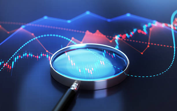 istock Magnifying Glass on Blue Red Financial Chart Background 2233598898