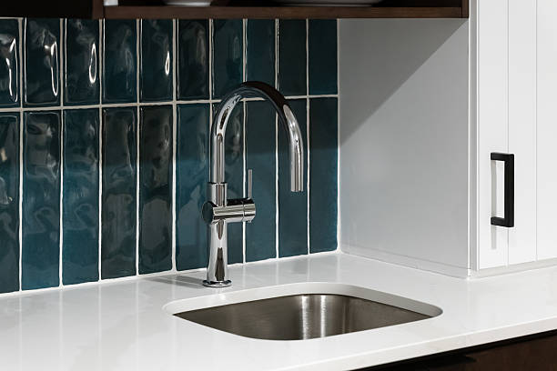 istock A kitchen faucet detail with a blue tiled backsplash. 2233599539