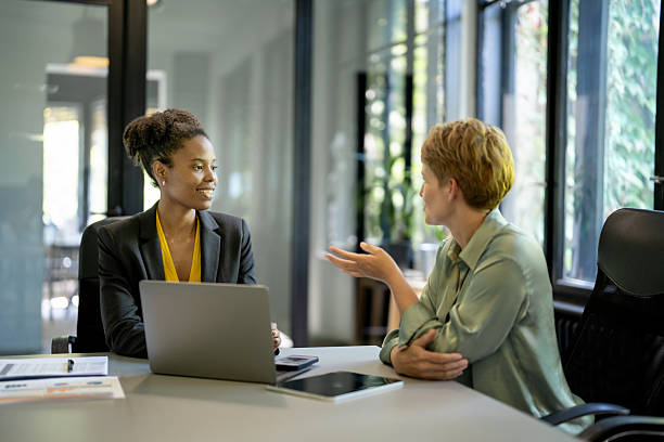 istock Two businesswomen collaborating on a project using laptop in modern office 2233601146