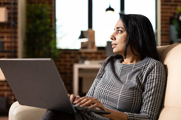 istock Indian businesswoman looking towards window in deep thought 2233606742