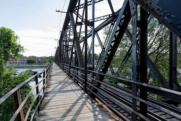istock Wooden Pedestrian Walkway on an Iron Truss Bridge Over a River 2233608449