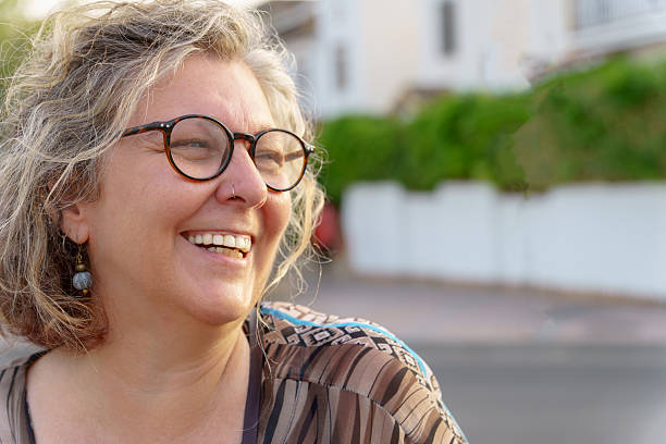 istock Happy senior woman smiling outdoors in urban setting 2233614473