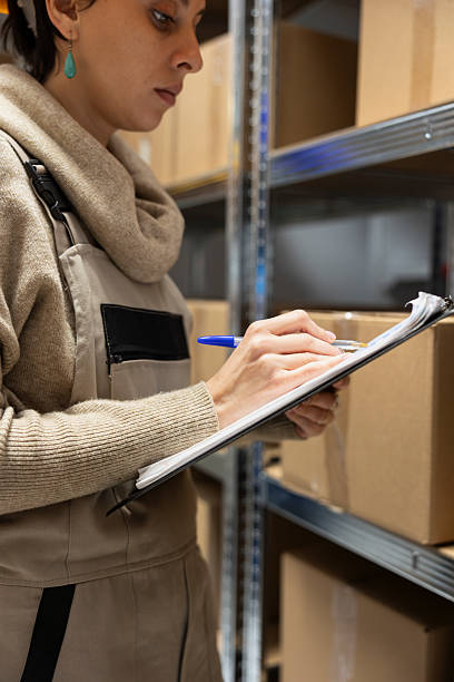 istock Female depot staff tracking orders and controlling warehouse merchandise 2233614850