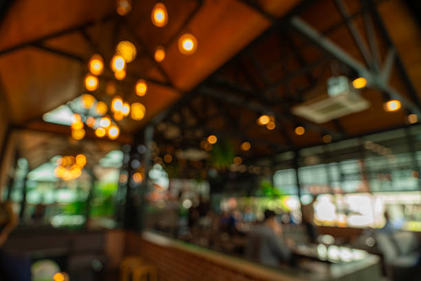 Blurred cafe and restaurant background featuring cozy atmosphere, coffee shop tables, and natural light. Perfect for remote working, creative design, lifestyle mockups, and presentation backdrops.