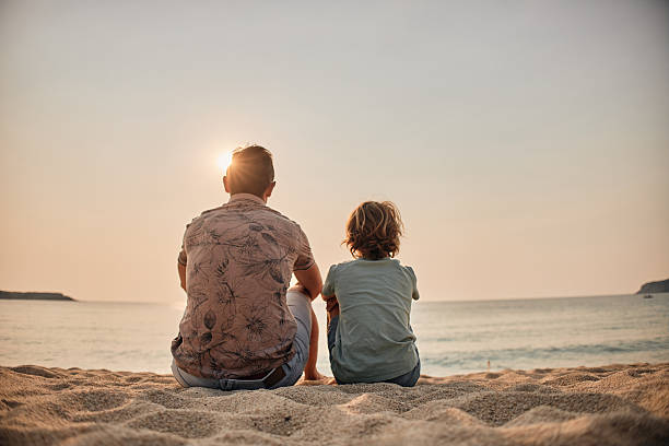 istock Father and son enjoying sun on the beach 2233618043
