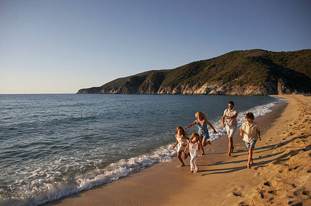 istock A family run down a tropical paradise beach during sunrise 2233618274