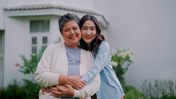istock Young Asian woman hugging elderly mother while visiting her at home. 2233618646