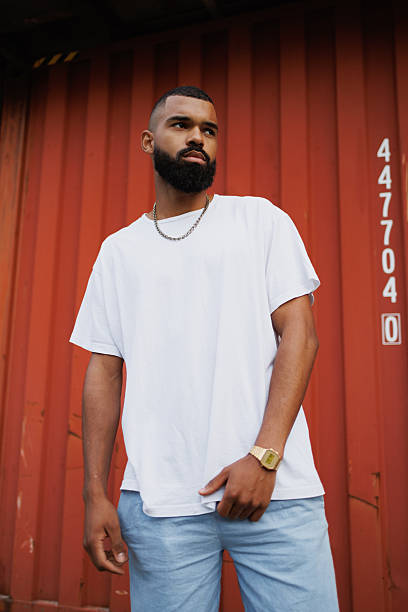 istock African american man in white t-shirt posing near cargo container 2233621841