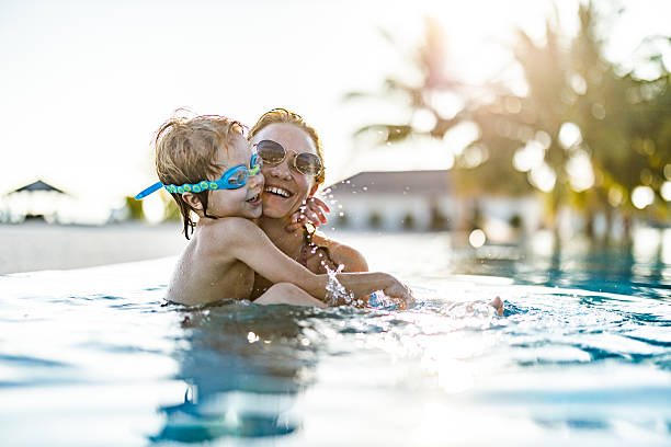 istock Happy boy embracing his single mother in the pool. 2233621909