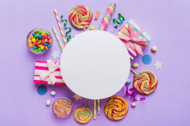 istock Flat lay holiday composition. Paper blank, lollipop, birthday decorations on Colored background. Top view, copy space for text 2233624126