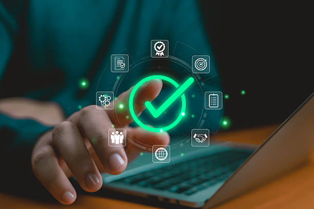 istock Digital approval and task completion concept with glowing green check mark icon, symbolizing business success, quality assurance, workflow efficiency, agreement, and project achievement Hand shows 2233624608