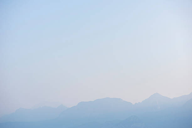istock silhouette of mountains at sunset, blue blurred natural background 2233626036