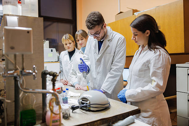 istock University students in lab coats practicing in faculty lab together 2233626234