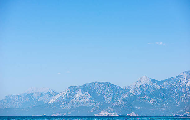 sea background with mountains, light blue haze