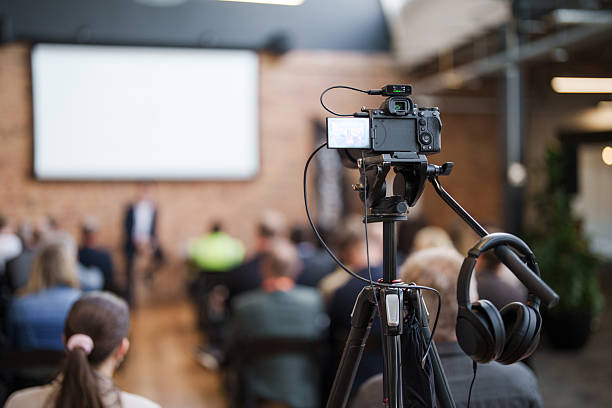 istock Filming equipment in conference hall for event coverage. 2233632208