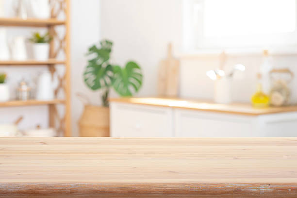 istock Close-up wooden table top on blurred bright rustic kitchen interior background 2233633007