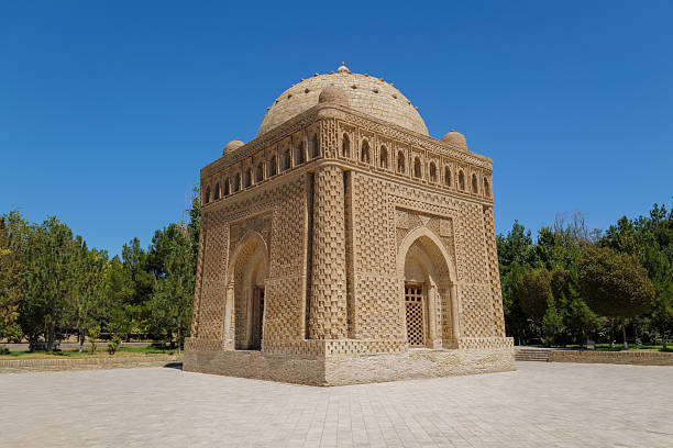 Uzbekistan, Bukhara, August 8, 2025\nThe Samanid Mausoleum, a masterpiece of Islamic architecture, built with decorative brick patterns and a central dome. Surrounded by a paved area and greenery under a bright blue sky. Perfect for concepts related to history, culture, and travel.