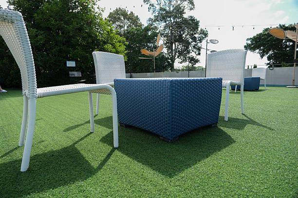 istock Angle view to woven plastic table and chairs outdoor hangout on the artificial grass. 2233636071