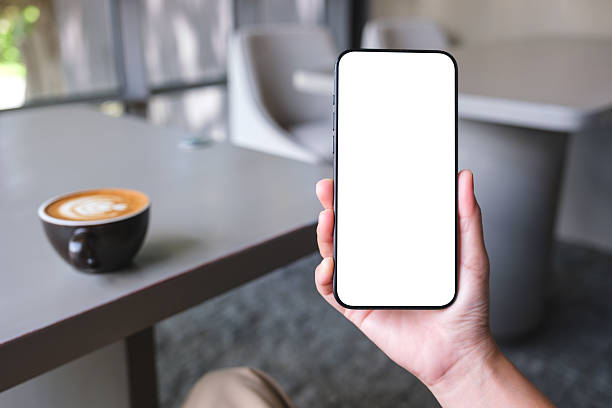 istock Mockup image of a woman holding and using mobile phone with blank desktop screen in cafe 2233636328