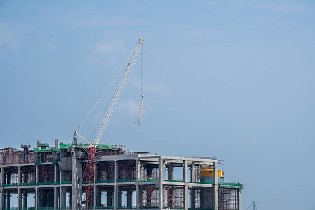 istock Construction Crane equipment and machinery over a building 2233636484