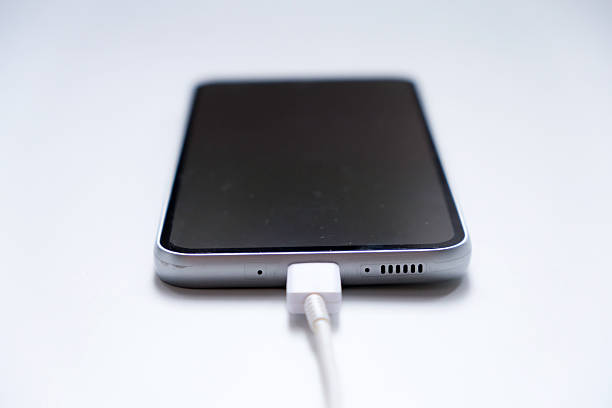 istock Charging mobile phone battery, isolated on white background 2233636858
