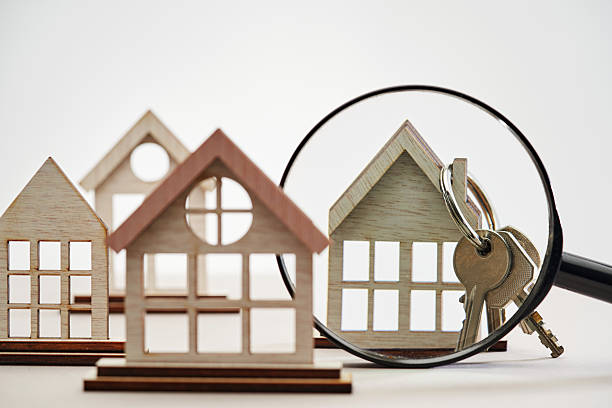 istock wood model house in a row against white background. 2233637637