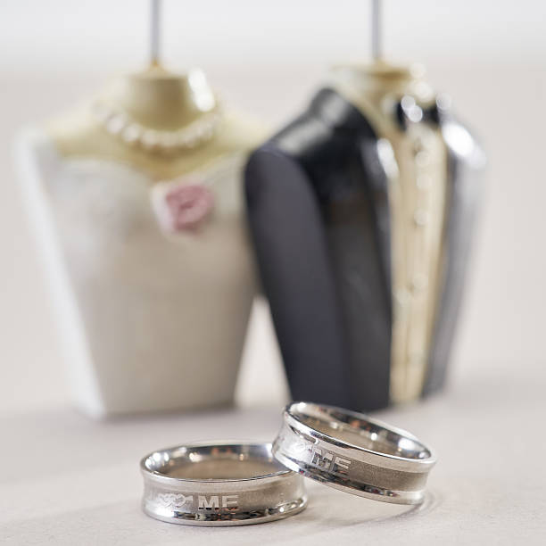 istock Silver wedding rings againstbride and groom figurine 2233637692