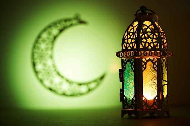 istock Crescent moon with lantern lamp against green background , Ramadan and Eid Mubarak concept background 2233637811