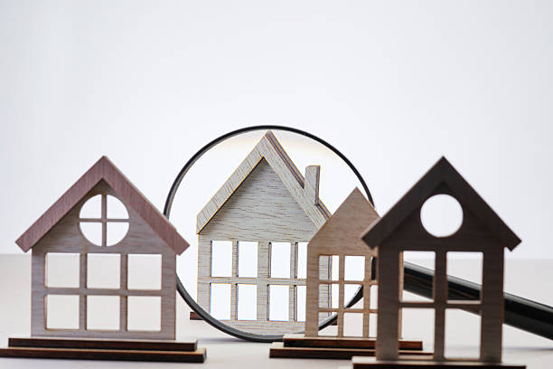 istock wood model house in a row against white background. 2233639670