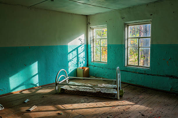 istock Abandoned room with a metal bed and natural light 2233640493