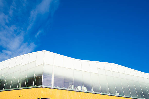 Closeup  detail of modern building, top part, white background with copy space, full frame horizontal composition