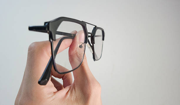 istock Hand Holding Eyeglasses Vision, Optical, and Clarity Concept 2233640909