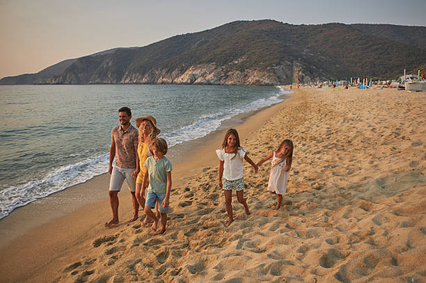 istock A family walks hand in hand down a tropical paradise beach during sunset 2233641012