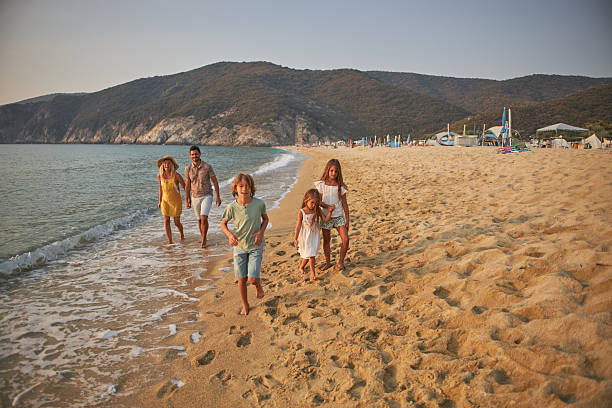 istock A family walks hand in hand down a tropical paradise beach during sunset 2233641111