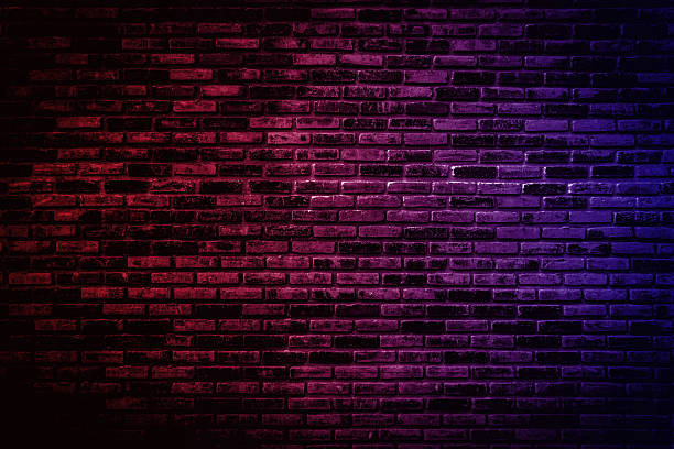 istock Neon light on brick walls that are not plastered background and texture. Lighting effect red and blue neon background vertical of empty brick basement wall. 2233641358