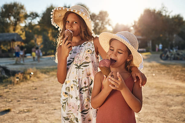 istock Beautiful kids enjoying ice cream on a beach 2233641854