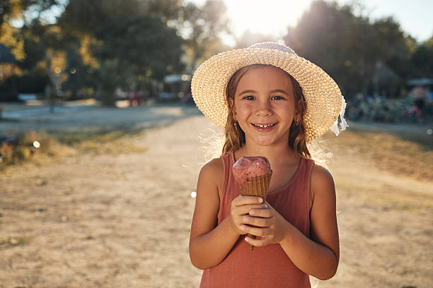 Beautiful girl enjoying ice cream on a beach vacation.