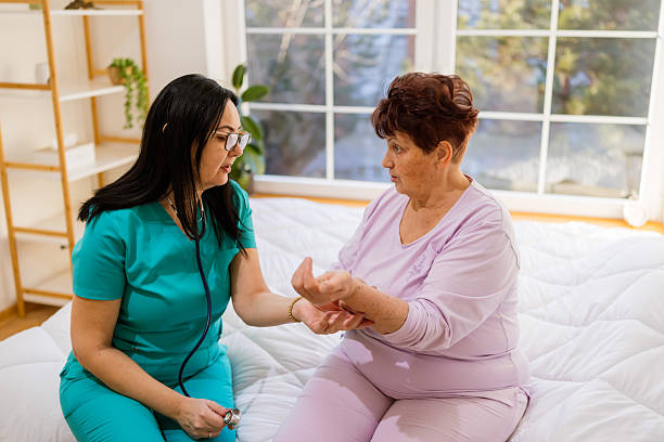 istock Senior woman sitting on bed explaining hands pain 2233642022