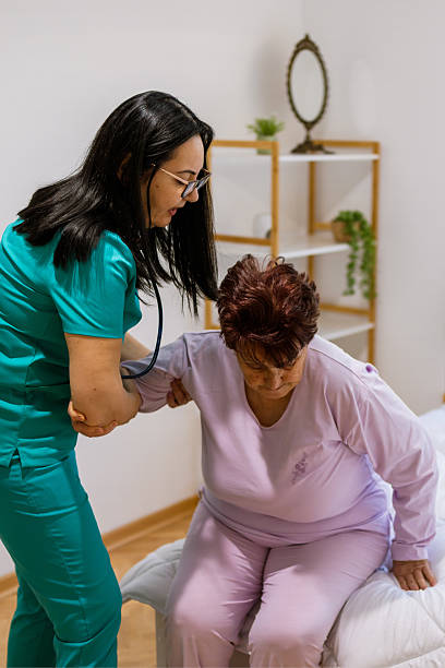 istock Nurse assisting patient to sit safely in bedroom 2233643305