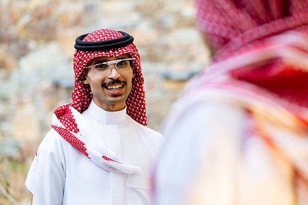 Emirati singers from UAE performing the Al-Ayyala stick dance at the traditional Moussem festival that takes place every spring in the moroccan city of Tan Tan.