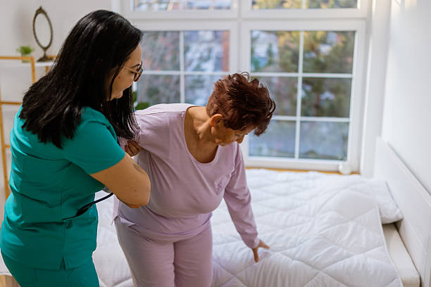 istock Elderly woman sitting with nurse assistance 2233643510