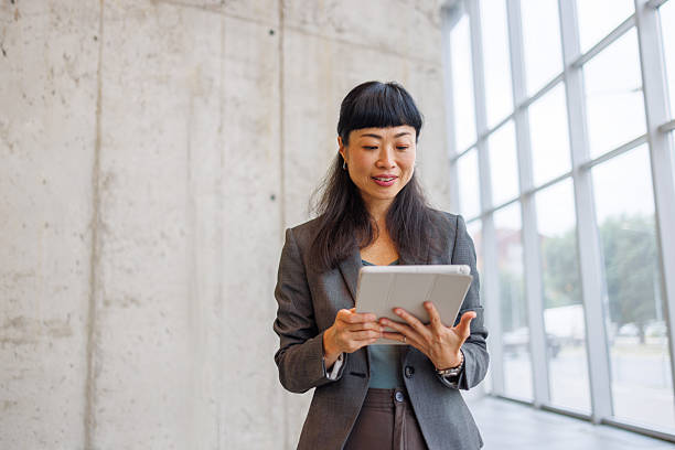 istock Businesswoman using digital tablet in modern office 2233644611