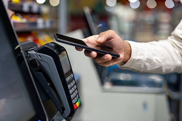 istock A person making a quick payment with a smartphone at a store's payment terminal. 2233645580