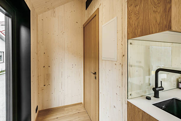 istock Minimal Wooden Interior with Door and Kitchen Detail 2233648478
