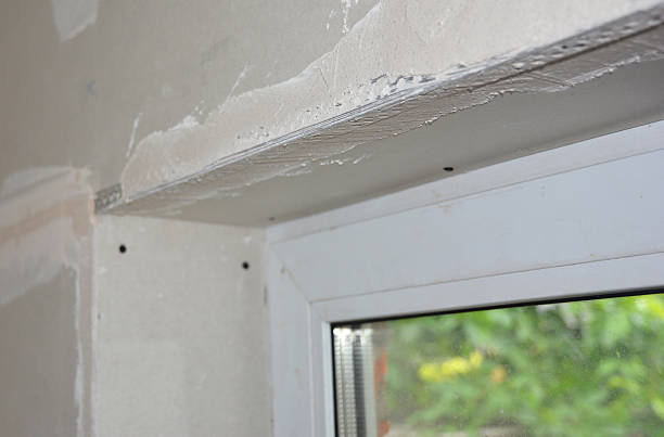 istock Plastering gypsum plasterboard on window indoor corner lintel 2233649392