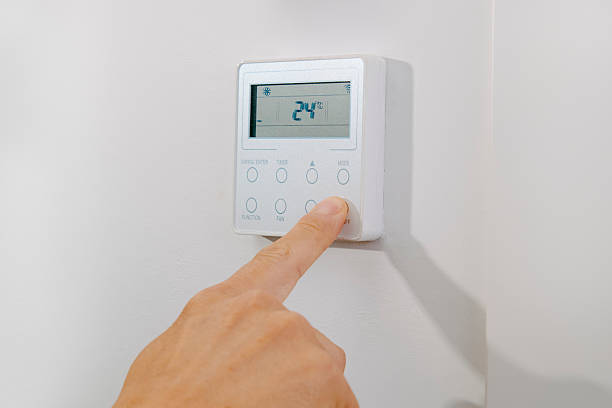istock man turning on or off the air conditioning 2233650574
