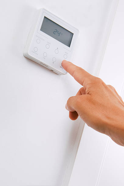istock a man turns on or off the air conditioner 2233650583